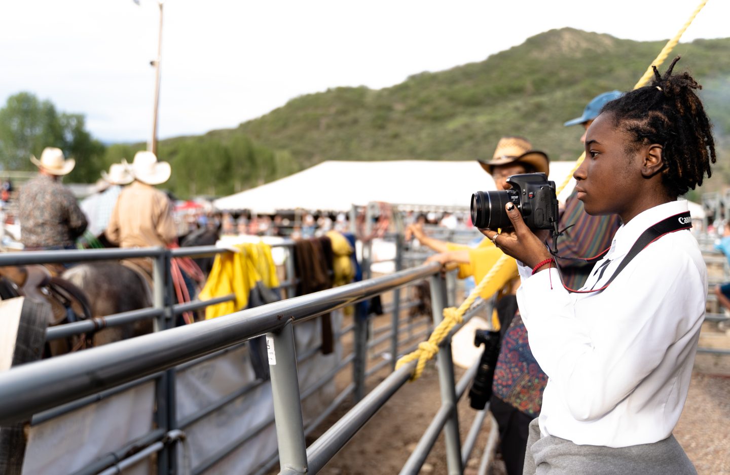 Student photographing the Snowmass Village rodeo during a field visit as part of a photography and new media workshop at Anderson Ranch Arts Center