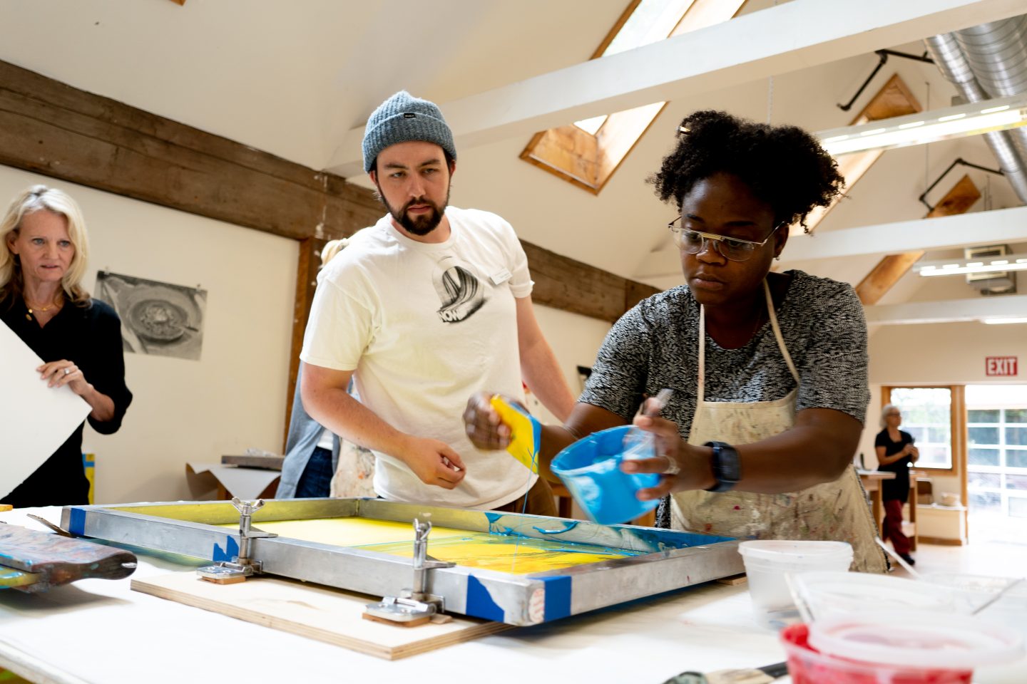 artist working with ink and paper in a printmaking studio at Anderson Ranch