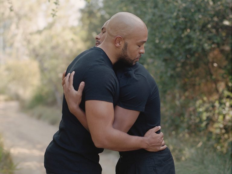 Portrait photograph by Erik Carter showing two men in an intimate embrace, featured for his Anderson Ranch workshop