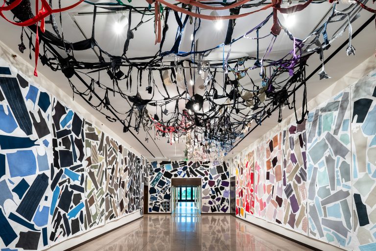 installation artwork composed of cut fabric, thread, adhesive, and Tyvek forming a suspended sculptural structure