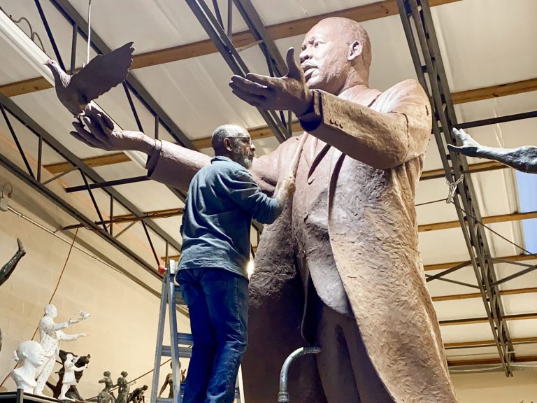 artist carving a clay figure sculpture of a male form in a studio at Anderson Ranch Arts Center